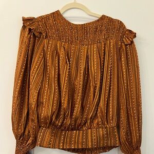 Metallic bronze dressy top. Never worn. Size small.